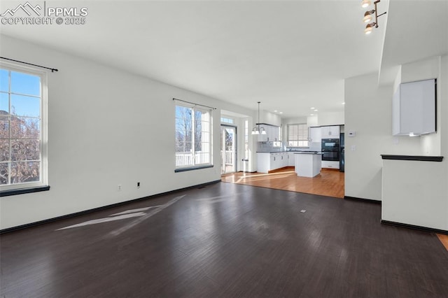 unfurnished living room featuring dark wood-type flooring