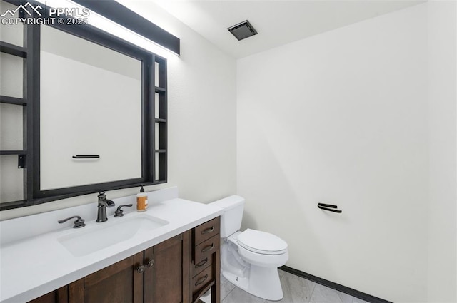 bathroom featuring vanity and toilet