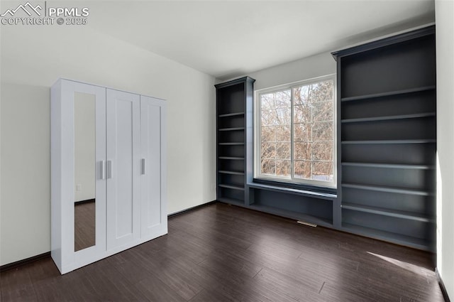 unfurnished bedroom featuring dark hardwood / wood-style flooring