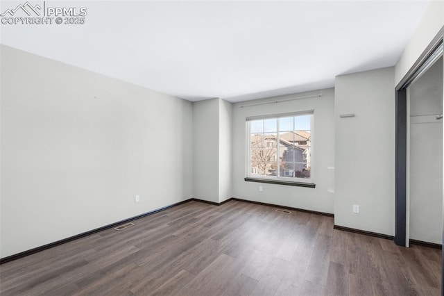 unfurnished bedroom featuring hardwood / wood-style flooring