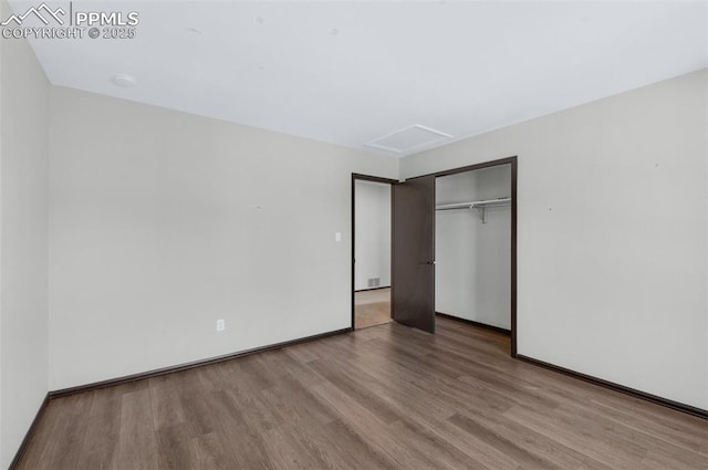 unfurnished bedroom with a closet and light hardwood / wood-style flooring