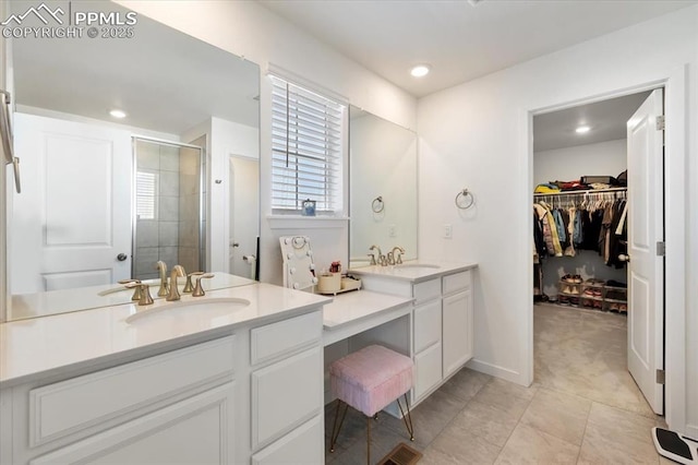 full bath featuring a walk in closet, a shower stall, vanity, and recessed lighting