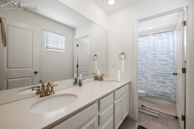 full bath with toilet, curtained shower, double vanity, and a sink