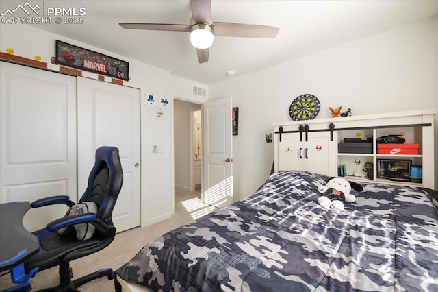 bedroom with carpet, visible vents, ceiling fan, and a closet