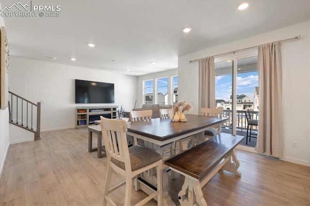 dining space featuring light wood-type flooring, stairway, and recessed lighting