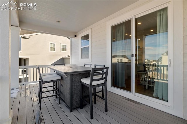 wooden deck featuring outdoor dining area