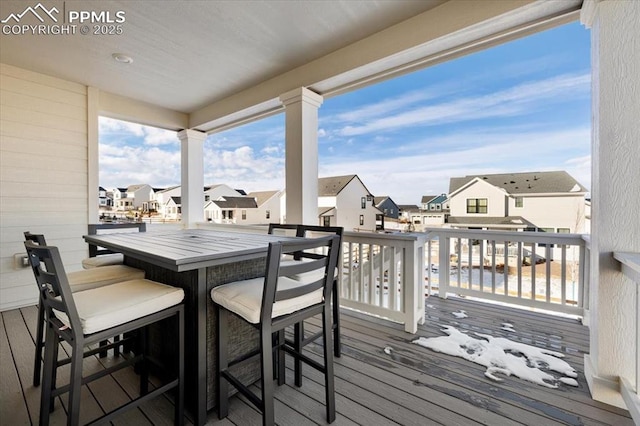 wooden deck with a residential view and outdoor dry bar