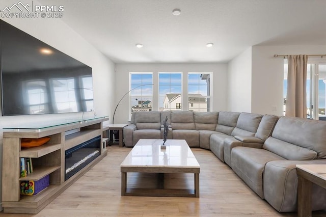 living room featuring light wood-type flooring and recessed lighting