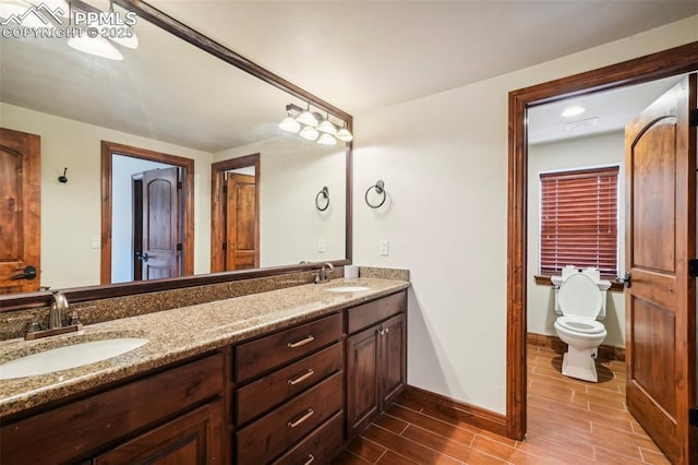 bathroom featuring toilet and vanity