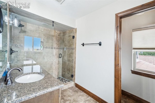 bathroom featuring tile patterned flooring, a shower with door, and vanity