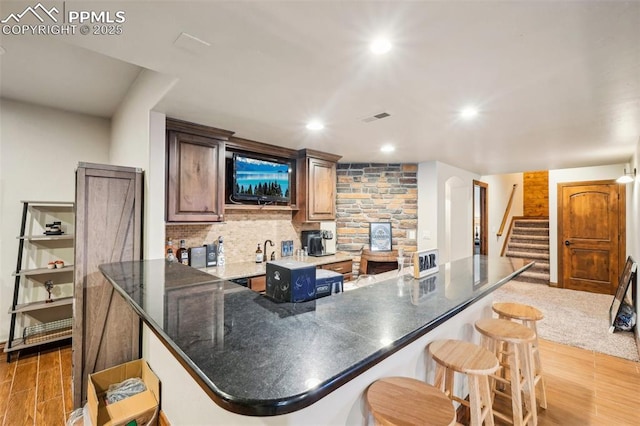 kitchen with a kitchen breakfast bar and tasteful backsplash