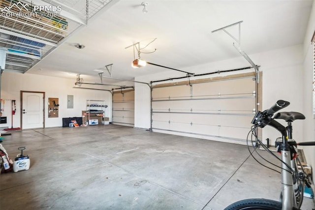 garage with a garage door opener and electric panel