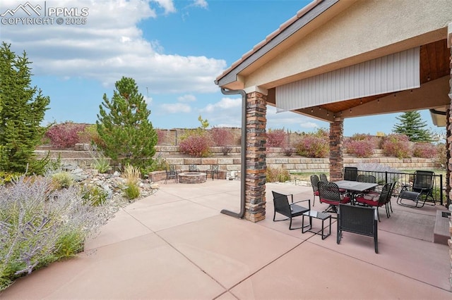 view of patio / terrace featuring an outdoor fire pit