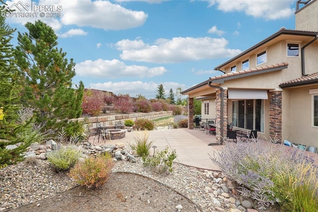 view of yard with a patio area and an outdoor fire pit