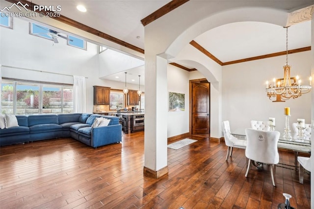 dining room with an inviting chandelier, dark hardwood / wood-style flooring, and ornamental molding