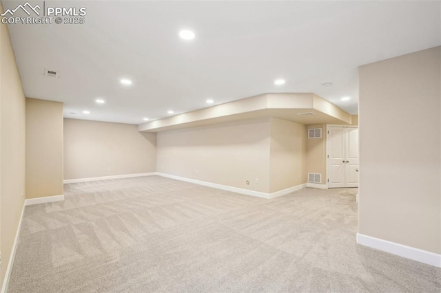 basement featuring light colored carpet