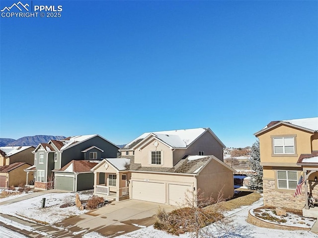 view of front of property featuring a mountain view and a garage