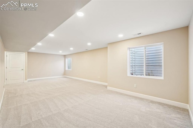 basement featuring light carpet