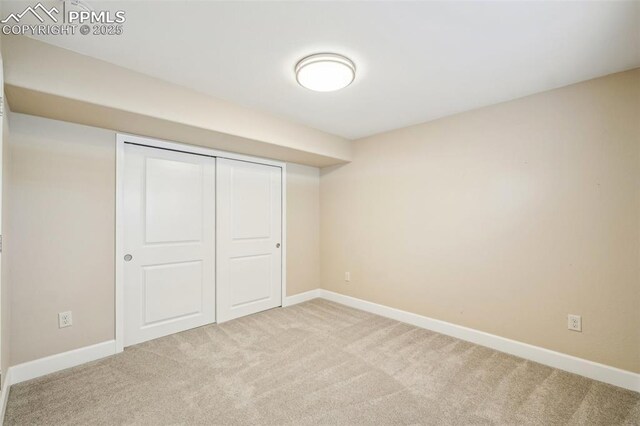 unfurnished bedroom featuring carpet floors and a closet