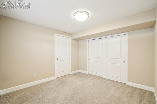 unfurnished bedroom with a closet and carpet flooring