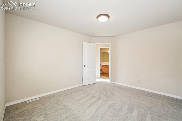 spare room with light colored carpet