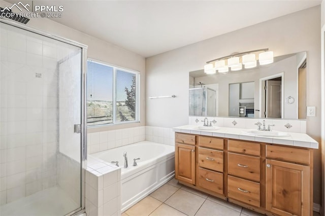 bathroom featuring plus walk in shower, tile patterned flooring, and vanity