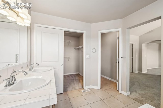 bathroom with tile patterned floors and vanity