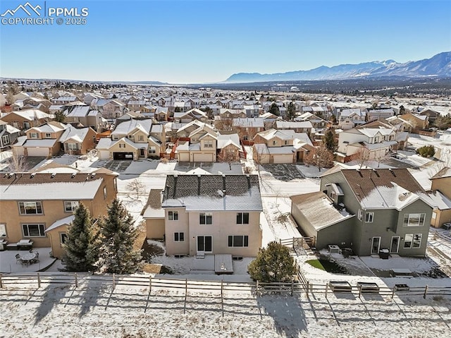 snowy aerial view featuring a mountain view