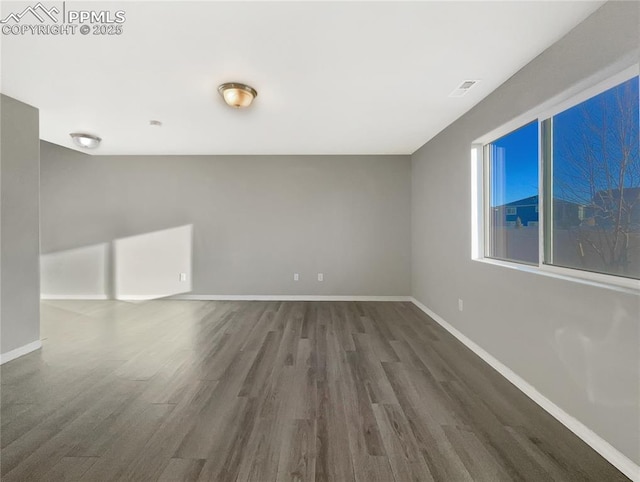 unfurnished room featuring dark hardwood / wood-style flooring