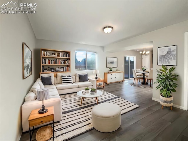 living room with a chandelier and dark hardwood / wood-style flooring