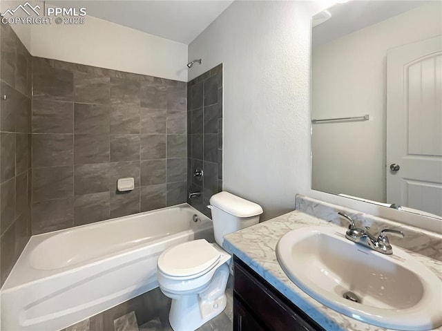 full bathroom with toilet, vanity, and tiled shower / bath