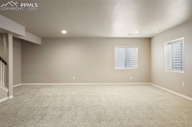 carpeted spare room with a textured ceiling