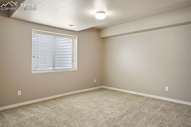 carpeted spare room with a textured ceiling