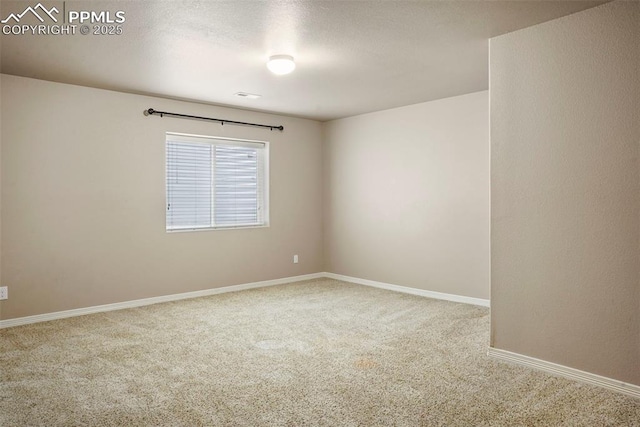 carpeted spare room featuring a textured ceiling