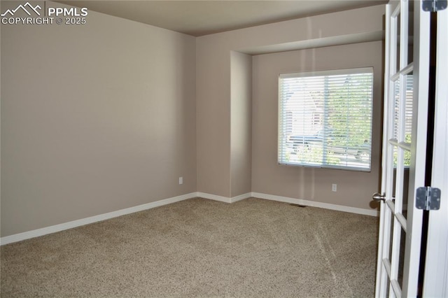 unfurnished room with light colored carpet