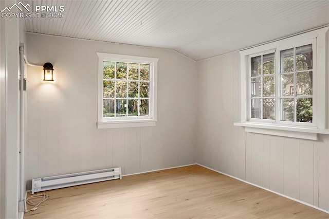 bonus room with a baseboard heating unit and light hardwood / wood-style flooring