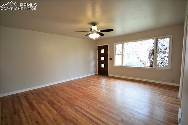 empty room featuring ceiling fan and hardwood / wood-style flooring