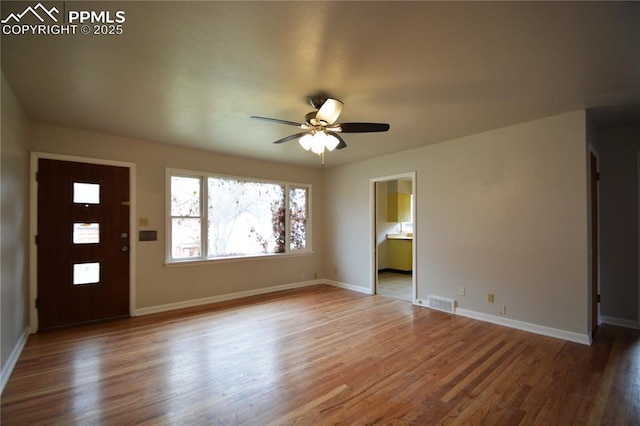 entrance foyer with ceiling fan and wood-type flooring