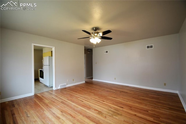 empty room featuring ceiling fan and hardwood / wood-style flooring