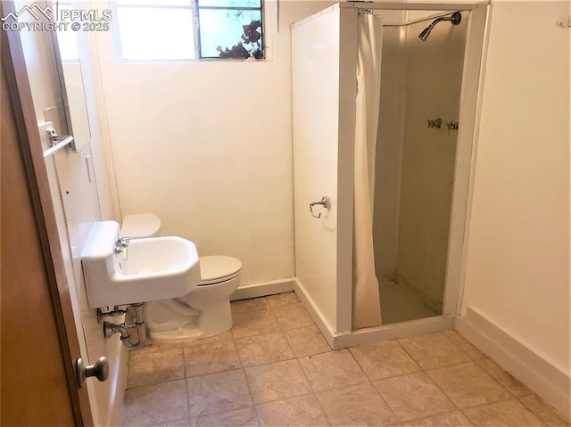 bathroom with toilet, walk in shower, and sink