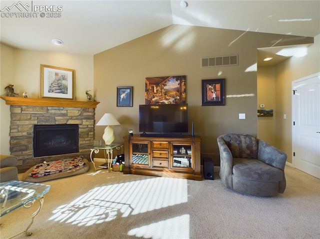 carpeted living room with lofted ceiling and a stone fireplace