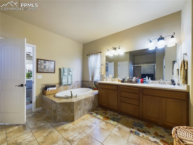 bathroom with tiled tub and vanity