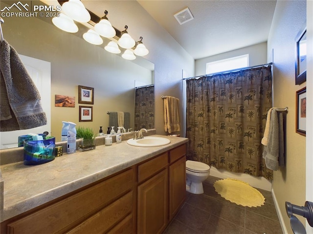 bathroom featuring toilet, vanity, tile patterned flooring, and curtained shower