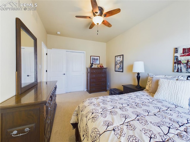 carpeted bedroom with ceiling fan and a closet