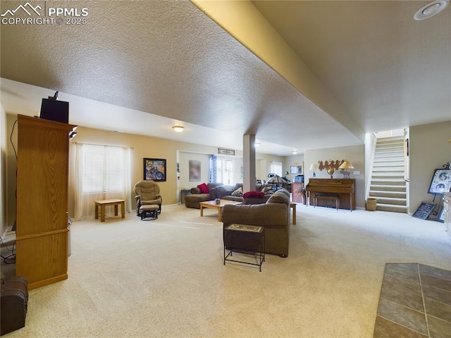 living room with a textured ceiling, a wealth of natural light, and carpet floors