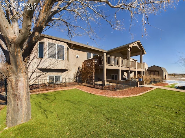 rear view of property featuring a wooden deck and a yard