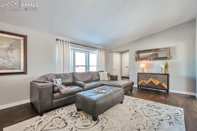 living area featuring lofted ceiling, baseboards, and wood finished floors