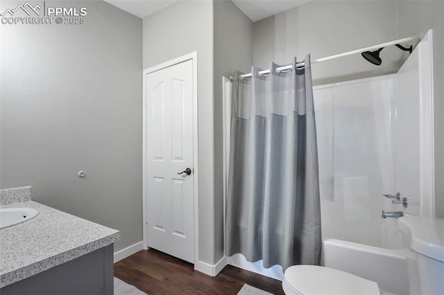 bathroom with baseboards, toilet, wood finished floors, shower / bathtub combination with curtain, and vanity