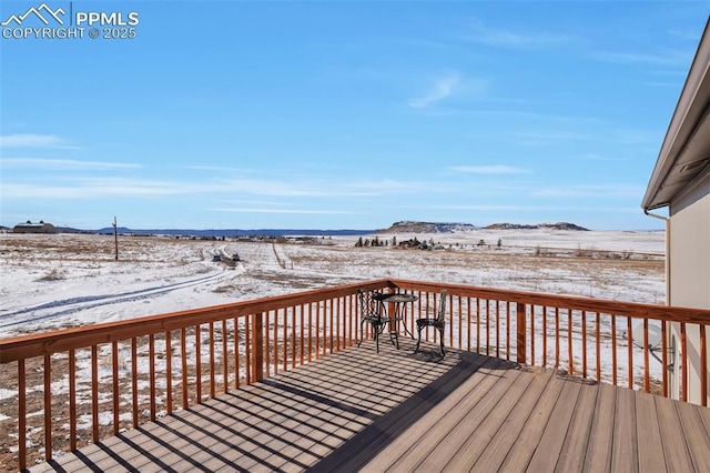 snow covered deck featuring a mountain view