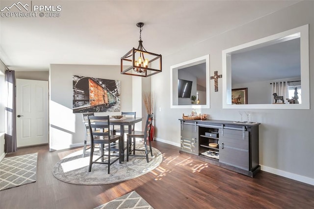 dining room with dark wood-style flooring, a notable chandelier, and baseboards